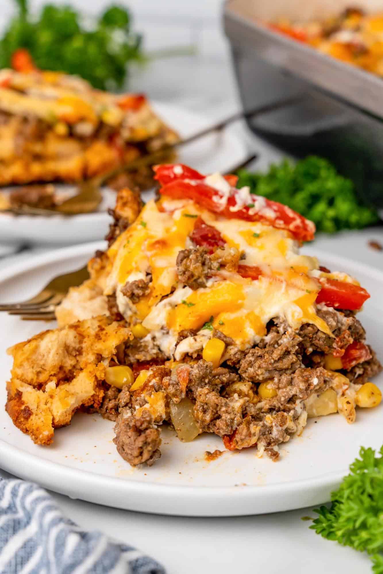 a single serving of john wayne casserole on a white dinner plate.
