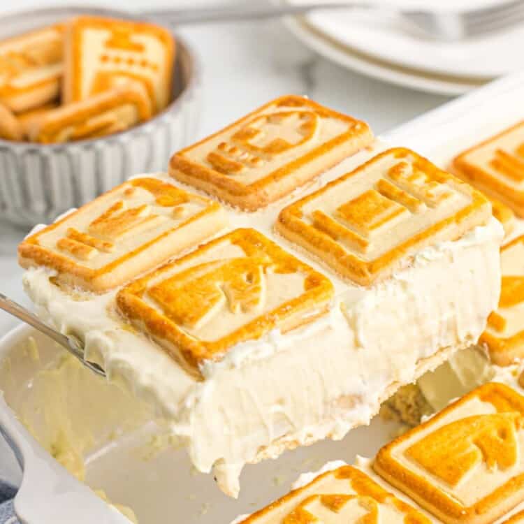 Taking a serving of Chessmen banana pudding from the ceramic dish