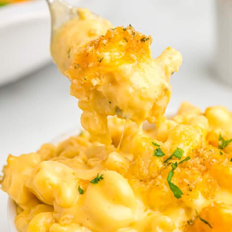 Velveeta mac and cheese served in a white bowl, eating from it with a fork