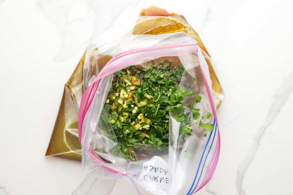 Fresh chopped jalapeno and cilantro in a ziplock bag of carne asada marinade.