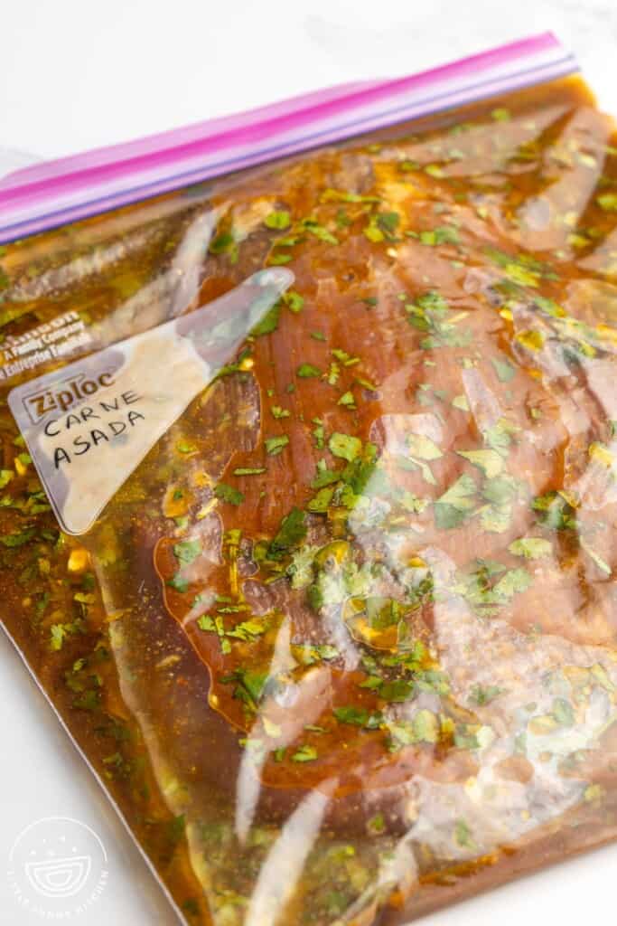 Steak in a ziploc bag marinating for carne asada