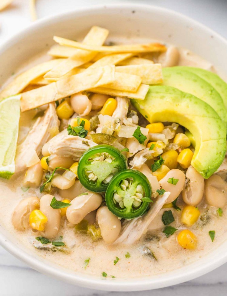 Crockpot White Chicken Chili served in a white bowl with toppings