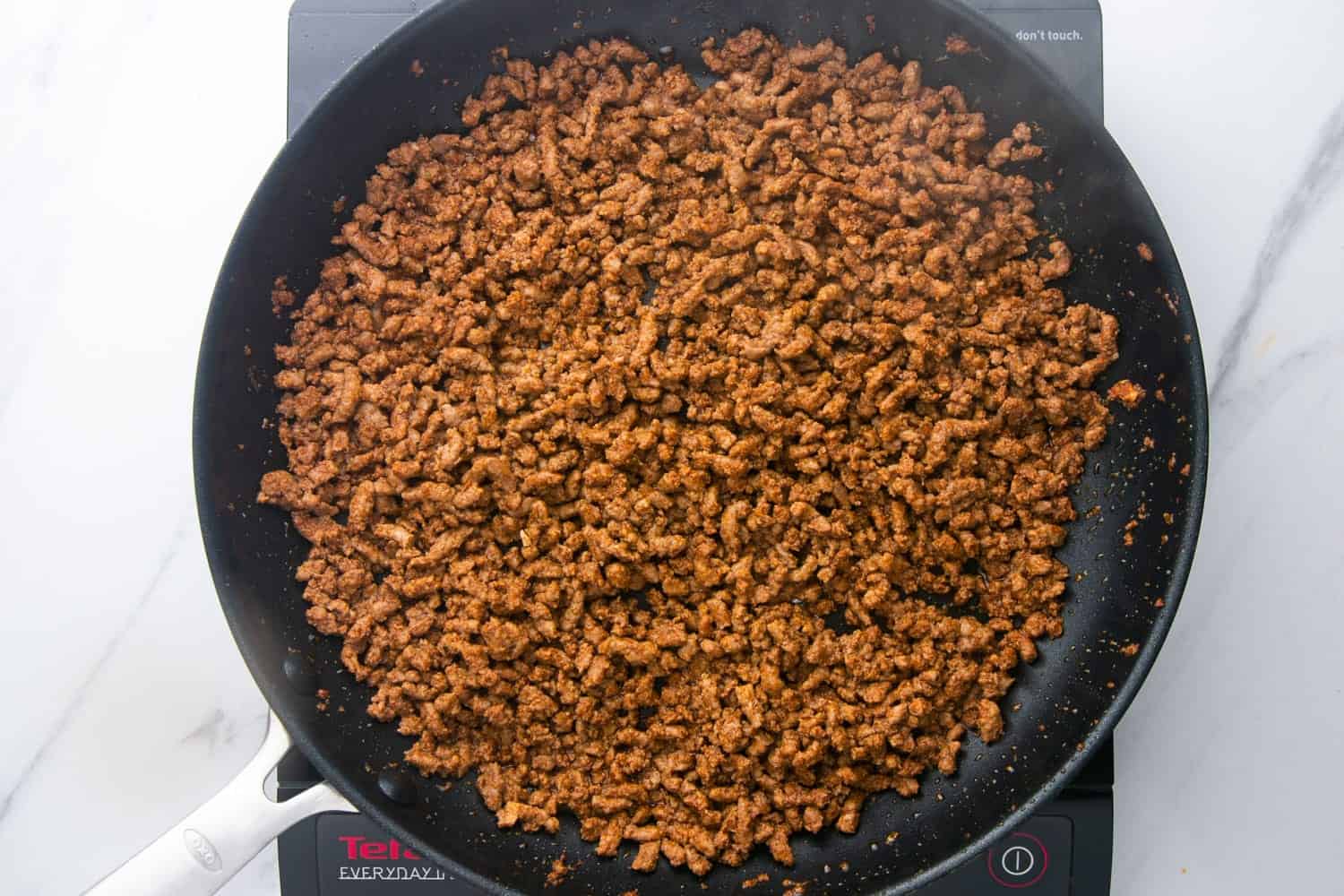 Seasoned taco ground beef in a skillet
