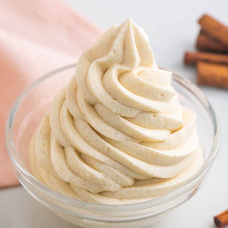 Piped cinnamon cream cheese frosting in a small bowl