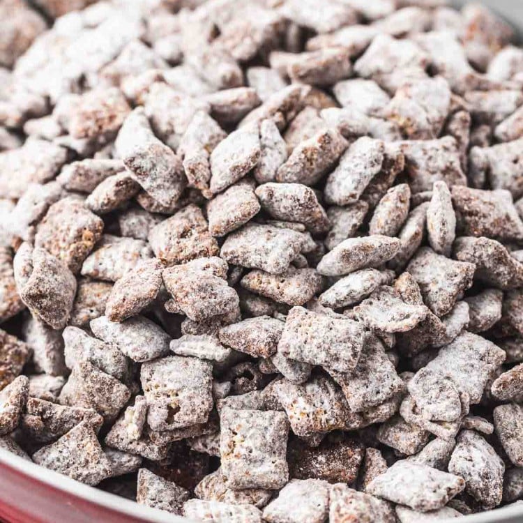 Puppy chow in a large white bowl, with a red tea towel
