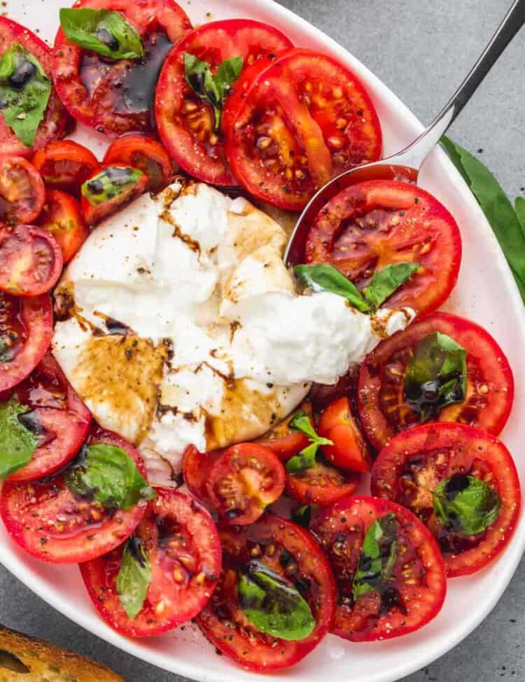 Overhead shot of a platter with burrata caprese