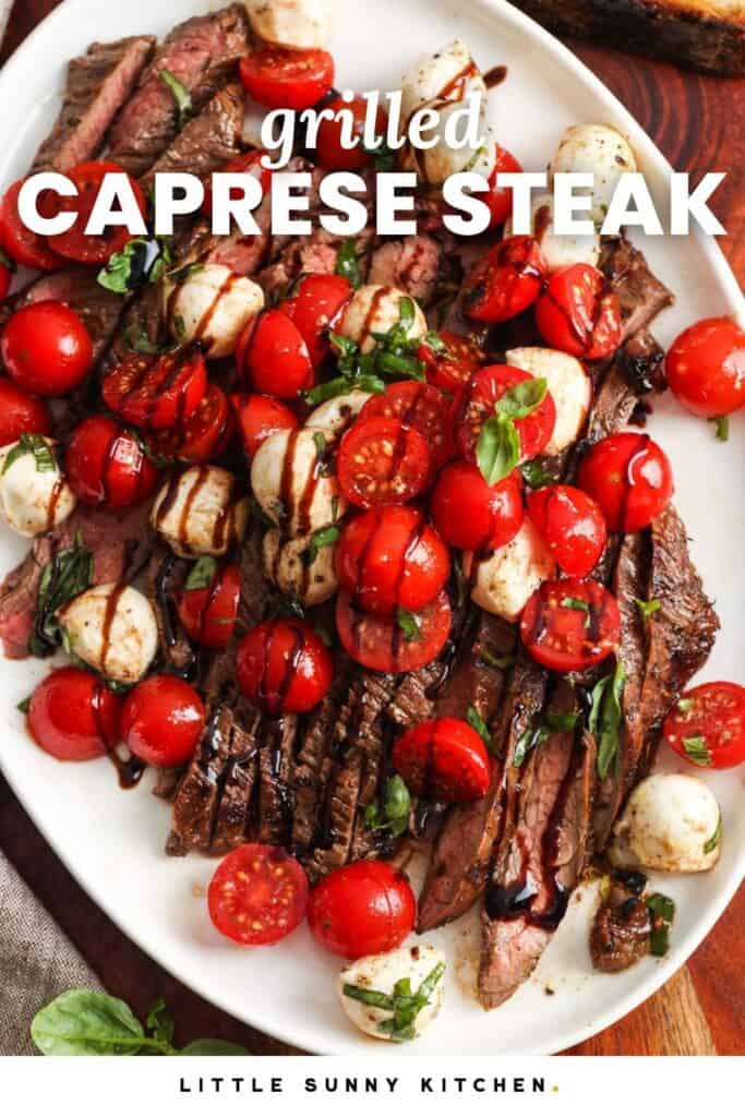Sliced grilled steak topped with cherry tomatoes, mozzarella pearls and drizzled with balsamic. Text overlay says" Grilled Caprese Steak"
